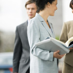 Businesswomen Discussing Agenda And Smiling